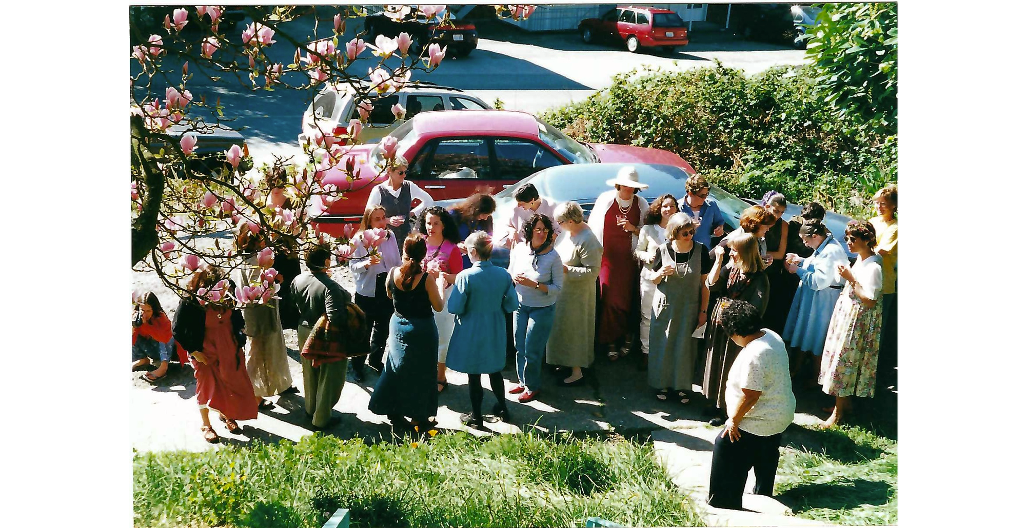 Photo of large group of women standing on sidewalk