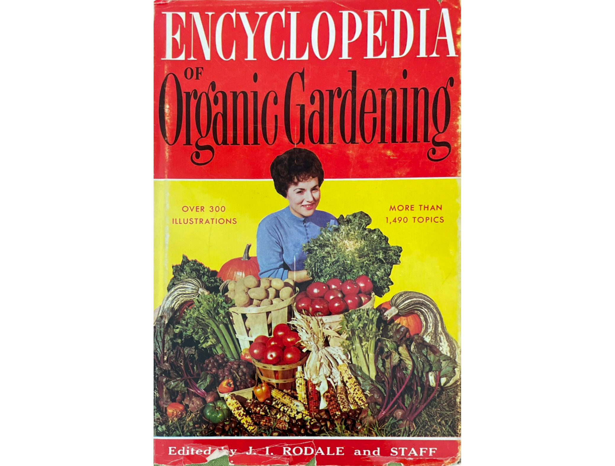 Photo of organic gardening book cover with 50's woman surrounded by vegetables.